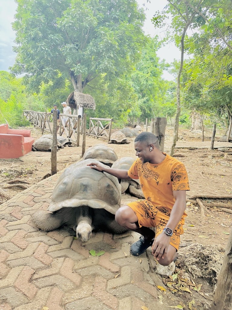 Benjamin Anyigor with a Turtle at Prison Island